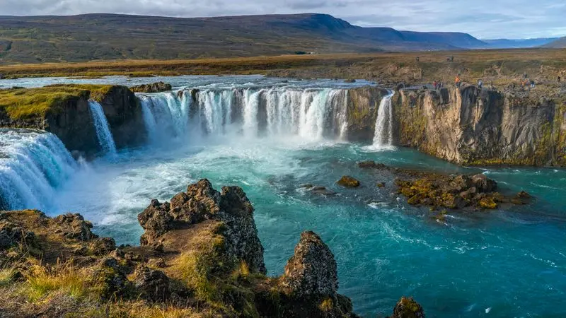 Dramatic waterfall cascading down Icelandic cliffs