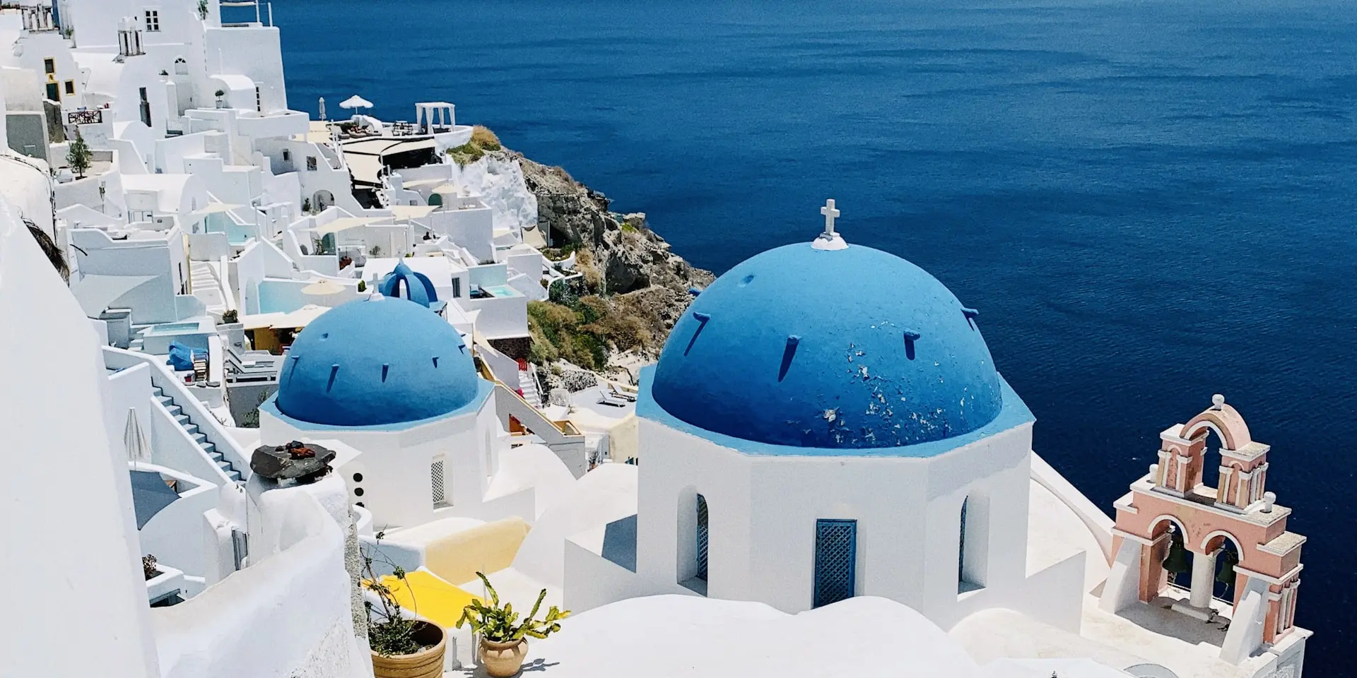 White-washed buildings and blue domes overlooking the Santorini caldera
